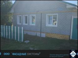Фасад одноэтажного дома обшитый термопанелями из бетона серого цвета